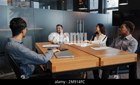 Office meeting multiracial employees work together teamwork discuss project business team multiethnic IT developers diverse people at company Stock Photo