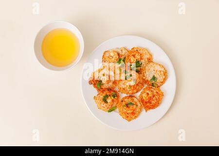 Banh khot Vung Tau, Vietnamese mini savory pancakes with with rice batter and shrimp, vietnamese food isolated on white background, top view Stock Photo