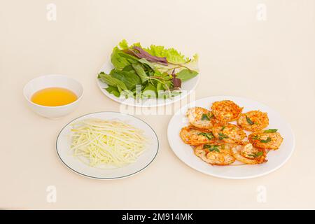 Banh khot Vung Tau, Vietnamese mini savory pancakes with with rice batter and shrimp, vietnamese food isolated on white background, perspective view Stock Photo