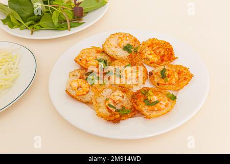 Banh khot Vung Tau, Vietnamese mini savory pancakes with with rice batter and shrimp, vietnamese food isolated on white background, close-up Stock Photo