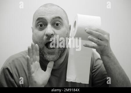 Man during a crisis in the bathroom Stock Photo