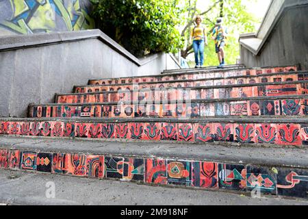 Mother and son walking on colourful vintage ceramic tiles on stairs in the streets of Tbilisi, Georgia, Europe Stock Photo