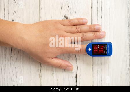 man using a pulse oximeter on his left index finger horizontal composition Stock Photo