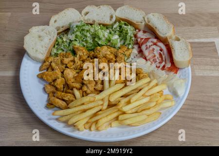 Bistro dishe culinary Still Life. Chicken Tajine with salad, tomato accompaniement onion, french fries and slice of bread Stock Photo