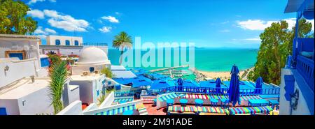 Panoramic view of open cafe and seafront with beach in Sidi Bou Said (blue white town). Tunisia, North Africa Stock Photo
