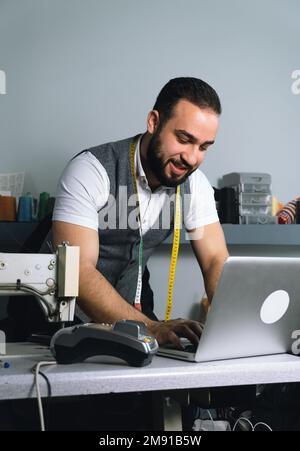 Tailor man working at his atelier Stock Photo