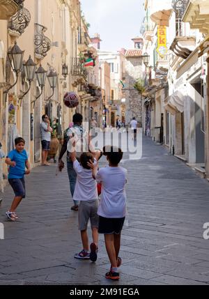 Children playing ball in Taormina Stock Photo