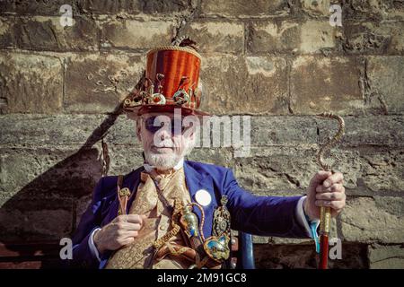 A stylish male wearing retro futuristic steampunk clothing and a wooden top hat. Stock Photo