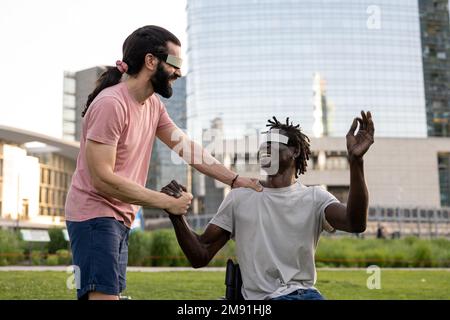 two friends using modern A.R. technology headsets, trying virtual reality outdoors, modern skyscrapers as background, futuristic lifestyle Stock Photo
