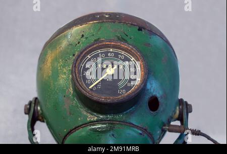 The old motorcycle headlight with speedometer, close-up view. Stock Photo