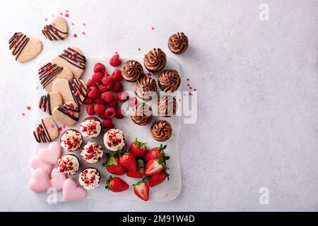 Valentines day charcuterie board with cupcakes and strawberries Stock Photo