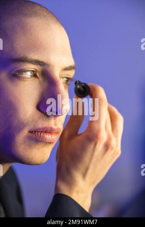 Close up face of a young homosexual man applying mascara. High quality photo Stock Photo