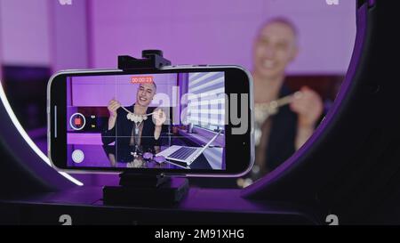 Phone screen close up of a man recording video content in a studio. High quality photo Stock Photo