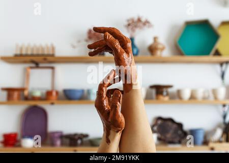 An expert potter, in his laboratory. The artisan creates works of art with his hands. Concept of: experience, art, tradition, clay. Banner, copy space Stock Photo