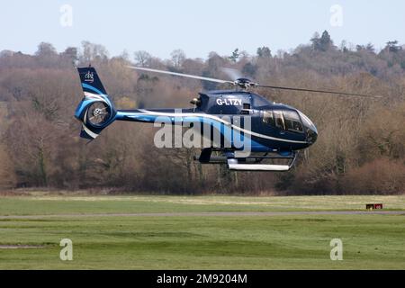 A Eurocopter EC 120B Colibri helicopter departs from Redhill Aerodrome Surrey Stock Photo