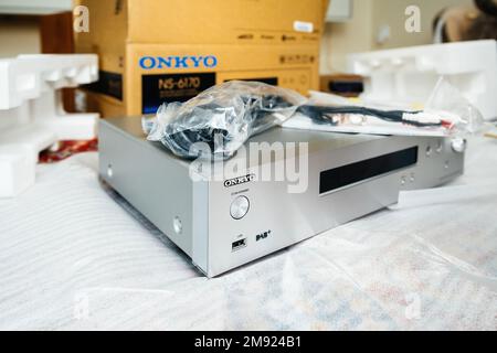 Paris, France - Dec 13, 2022: Focus on the logotype of Onkyo NS-6170 network audio player with DSD Hi-Res Audio and DSD DAB WIFI device after unboxing unpaacking - usb port power button Stock Photo