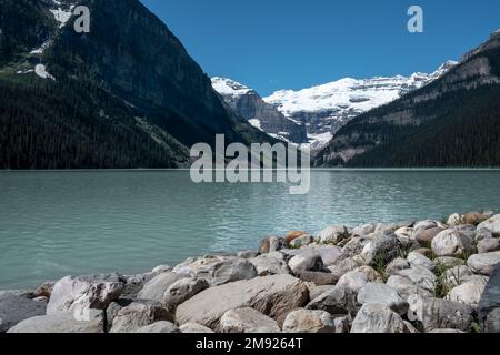 Observing the gigantic mountains around lake Louise in Canada Stock Photo
