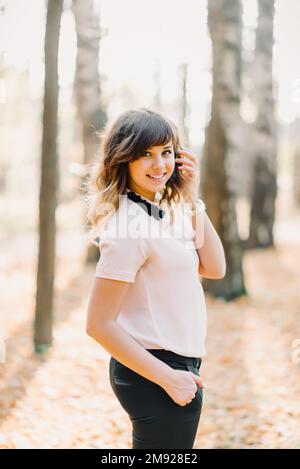 portrait of brunette girl Caucasian appearance smiling in Park in autumn Stock Photo