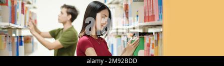 Banner with students choosing books in school library Stock Photo
