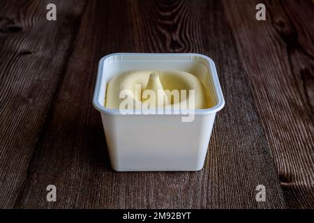 Plastic container contains vegetable oil spread. Stock Photo