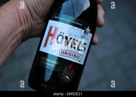 A closeup top view shot of a Hovels beer bottle in the palm of a person Stock Photo