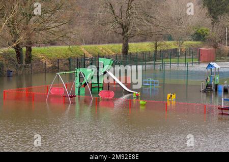 Taffs Well, Cardiff, Wales - January 2023: Children's playground in the village underwater after flooding from the River Taff Stock Photo