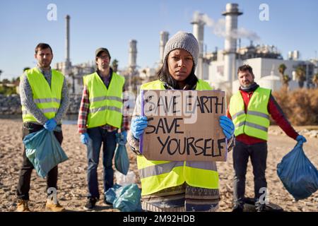 Protester young latin activist looking at camera holding a banner Stock Photo