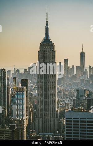 Aerial view of skyscrapers near famous tall Empire State Building in New York City at sundown in evening Stock Photo