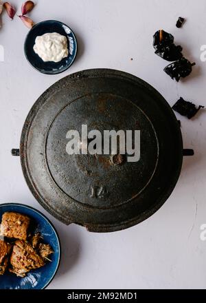 Top view of metal pan with cooked dish from the region of Murcia in Spain placed on table among bowls with ingredients Stock Photo
