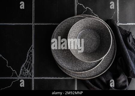 Dark dinnerware in set on concrete table Stock Photo