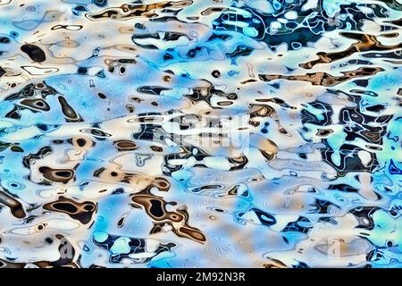 Top view of colorful abstract pattern in water with ripples on sunny summer day Stock Photo