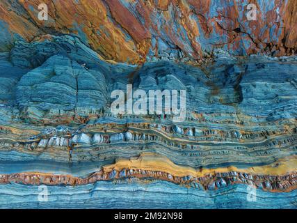 Textured background of uneven surface of brown and blue surface of rough rocky formation in Asturias Stock Photo