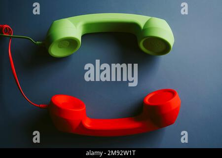 Top view of retro telephone handsets placed on gray background Stock Photo