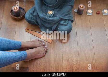 Crop woman meditating on floor Stock Photo - Alamy