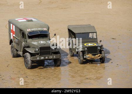 Arromanches, Normandy, France, June, 02, 2019 Two historic World War II US Army vehicles are parking on  Gold Beach Stock Photo