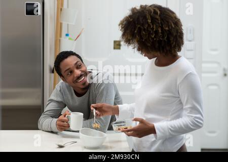 Happy african american couple having breakfast at home Stock Photo
