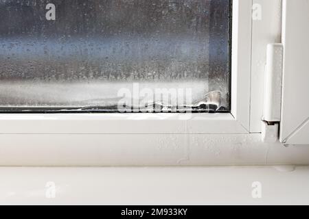 Frozen window frame condensation inside, close up. Ice builtup on black  metal window frame due to excessive moisture or vapour in the house and  freezi Stock Photo - Alamy