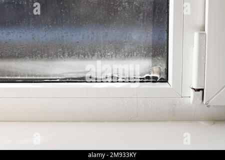 Frozen window frame condensation inside, close up. Ice builtup on