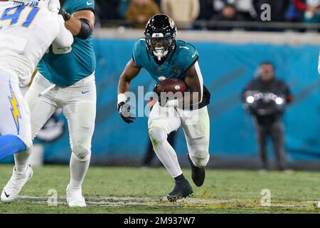 Jacksonville Jaguars running back Travis Etienne Jr. (1) runs the ball  during an NFL wild-card football game against the Los Angeles Chargers,  Saturday, Jan. 14, 2023, in Jacksonville, Fla. The Jaguars defeated