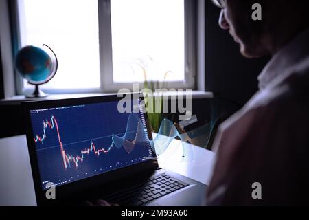 Businessman trading online stock market concept or forex investment exchange. Bitcoins, futures. Crypto currency chart with values moving up and down, trading statistics and analytics on laptop screen forex background Binar. stockbroker. checking price chart on digital exchange. Forex trading agency worker agent reviewing profits growth. Another crisis is coming and prices on the charts are falling down. finance business stock exchange graph chart, crypto, blockchain data analytics report analyzing. business man working on financial report. High quality photo Stock Photo