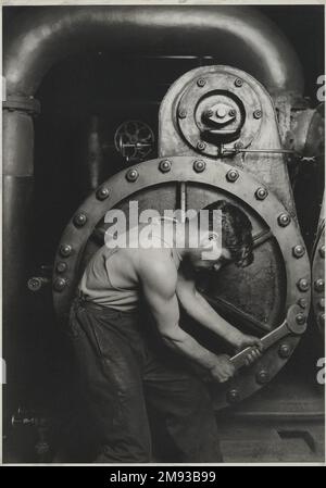 Power House Mechanic Lewis Wickes Hine (American, 1874-1940). , 1920-1921. Gelatin silver photograph, image: 13 1/2 x 9 1/2 in. (34.3 x 24.1 cm).  The clean muscularity and precise industrial order presented by Lewis Hine in Power House Mechanic demonstrates the photographer’s shift, in 1919, from a gritty documentary style to what he called “interpretive photography”—an approach intended to raise the stature of industrial workers, who were increasingly diminished by the massive machinery they operated. Despite his concern for the worker, Hine’s use of hand-selected and precisely posed models Stock Photo