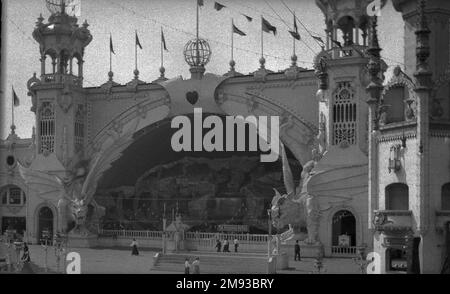 Luna Park, Coney Island Eugene Wemlinger. Luna Park, Coney Island, 1906. Cellulose nitrate negative, 5 3/4 x 3 1/2 in. (14.6 x 8.9 cm).  The Dragon’s Gorge was an enclosed roller coaster, a scenic railroad that brought the passenger on a fantastic trip from the bottom of the sea, through a waterfall, to the North Pole, Africa, the Grand Canyon, and even into Hades, the kingdom of death, over the river Styx. Two dragons framed the entrance, their eyes glowing from globes of green electric light. The ride caught fire in 1944, ultimately leading to the closing of the park two years later.  1906 Stock Photo