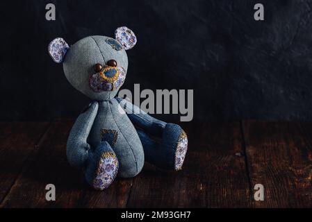 Handmade Teddy Bear Sitting on Wooden Table Stock Photo