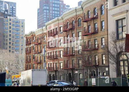 Streetside fire escapes on apartment buildings along 96th Street near Lexington Avenue on the East Side of Manhattan, New York City. Stock Photo