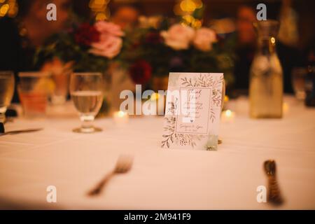 wedding venue tables flowers alcohol reception celebration candles Stock Photo