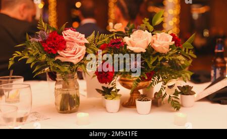 wedding venue tables flowers alcohol reception celebration candles Stock Photo