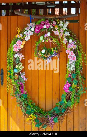 Easter Eggs wreath with flowers on front door. Traditional decoration for Easter. . High quality photo Stock Photo