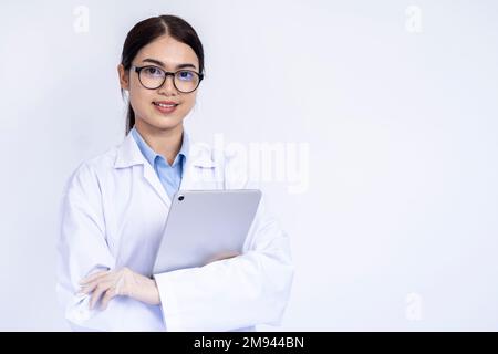 Portrait of female doctor in medical coat standing on isolated white background Stock Photo