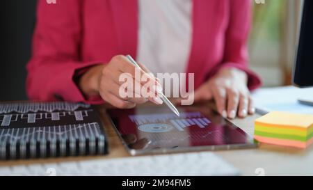 Financial manager works with financial documents on tablet in office. Stock Photo