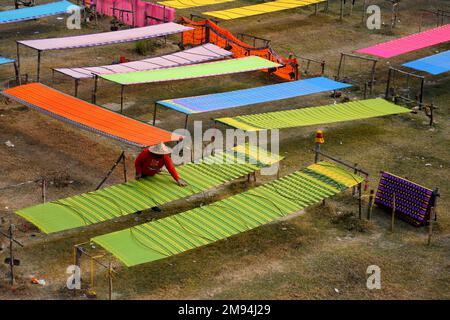 Shantipur, India. 14th Jan, 2023. A view of colourful Indian sarees drying under sun. The saree is a traditional form of dress for women in India. In Santipur & Fulia in the Nadia district of West Bengal, India 90 % of the population are engaged in weaving activities, and have been for generations. Credit: SOPA Images Limited/Alamy Live News Stock Photo